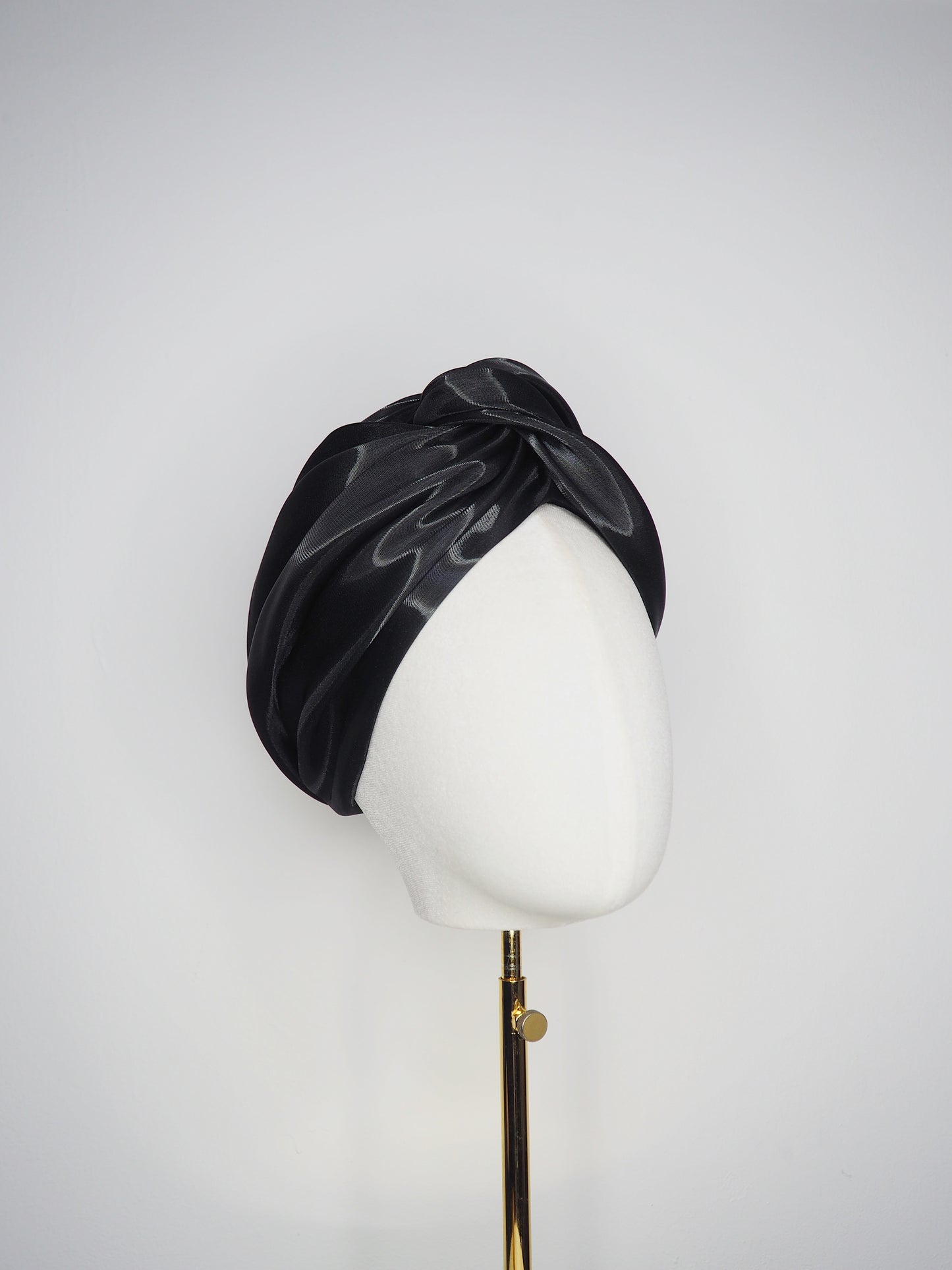 Glass Lake - A sculptural blocked turban crafted from luminous fabric inspired by morning reflections on water.