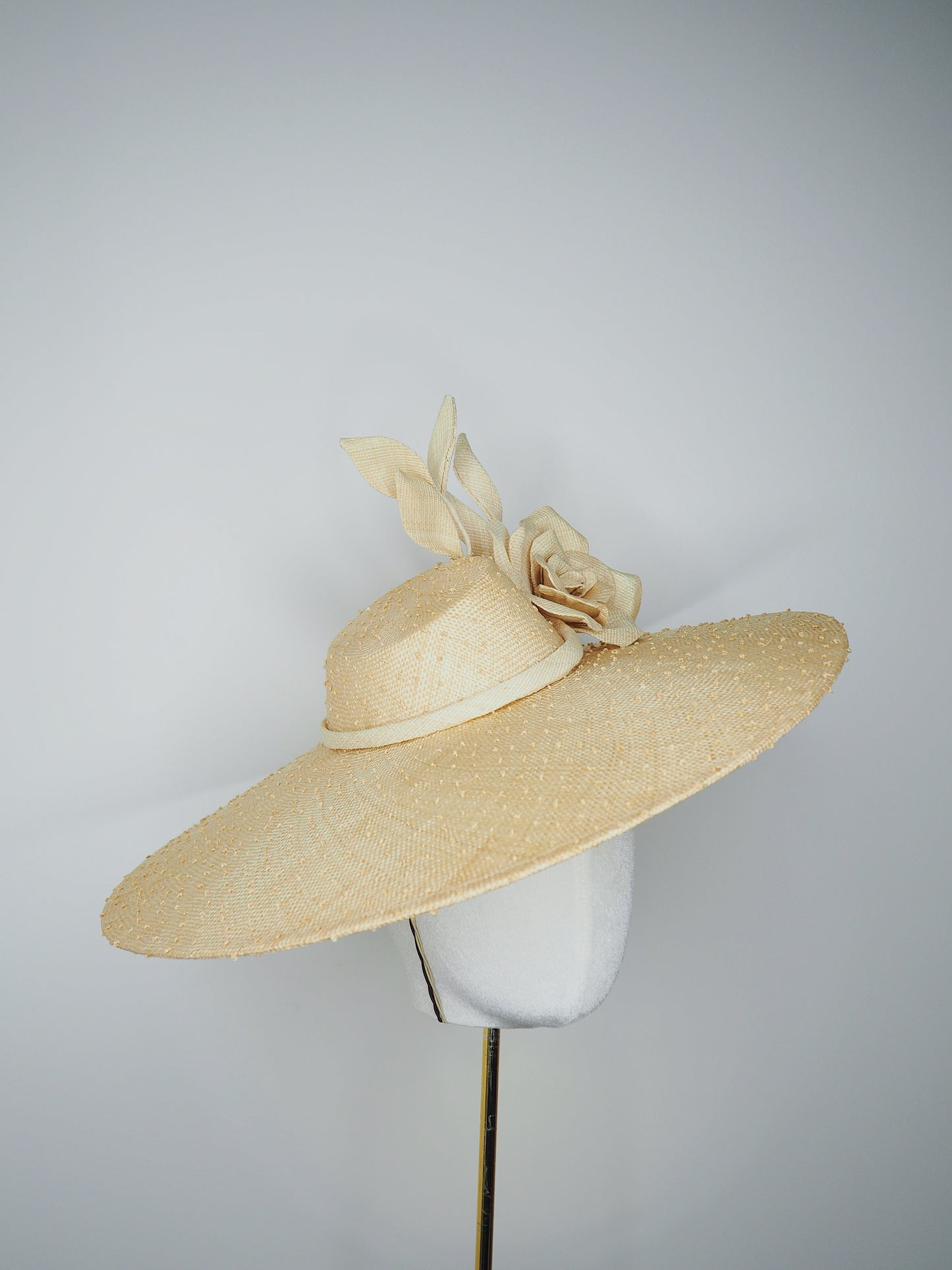 Nature in Bloom-Natural straw asymmetric brim hat with hand-sculpted rose and swirls