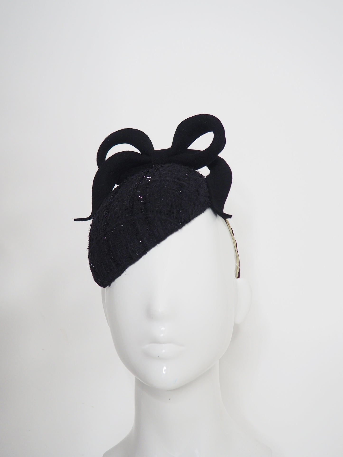Baby Bow - Black fur felt sculpted bow on a tweed petite facehugger base.