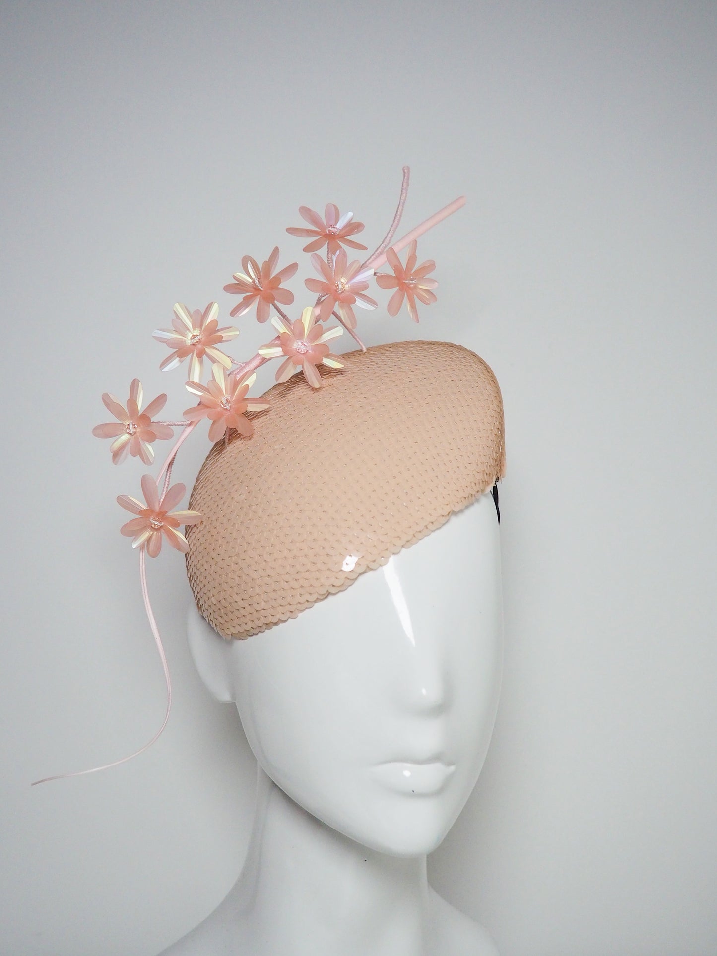 Peachy Pink - Iridescent pastel pink blossoms and quill on a peach blossom sequin facehugger base.