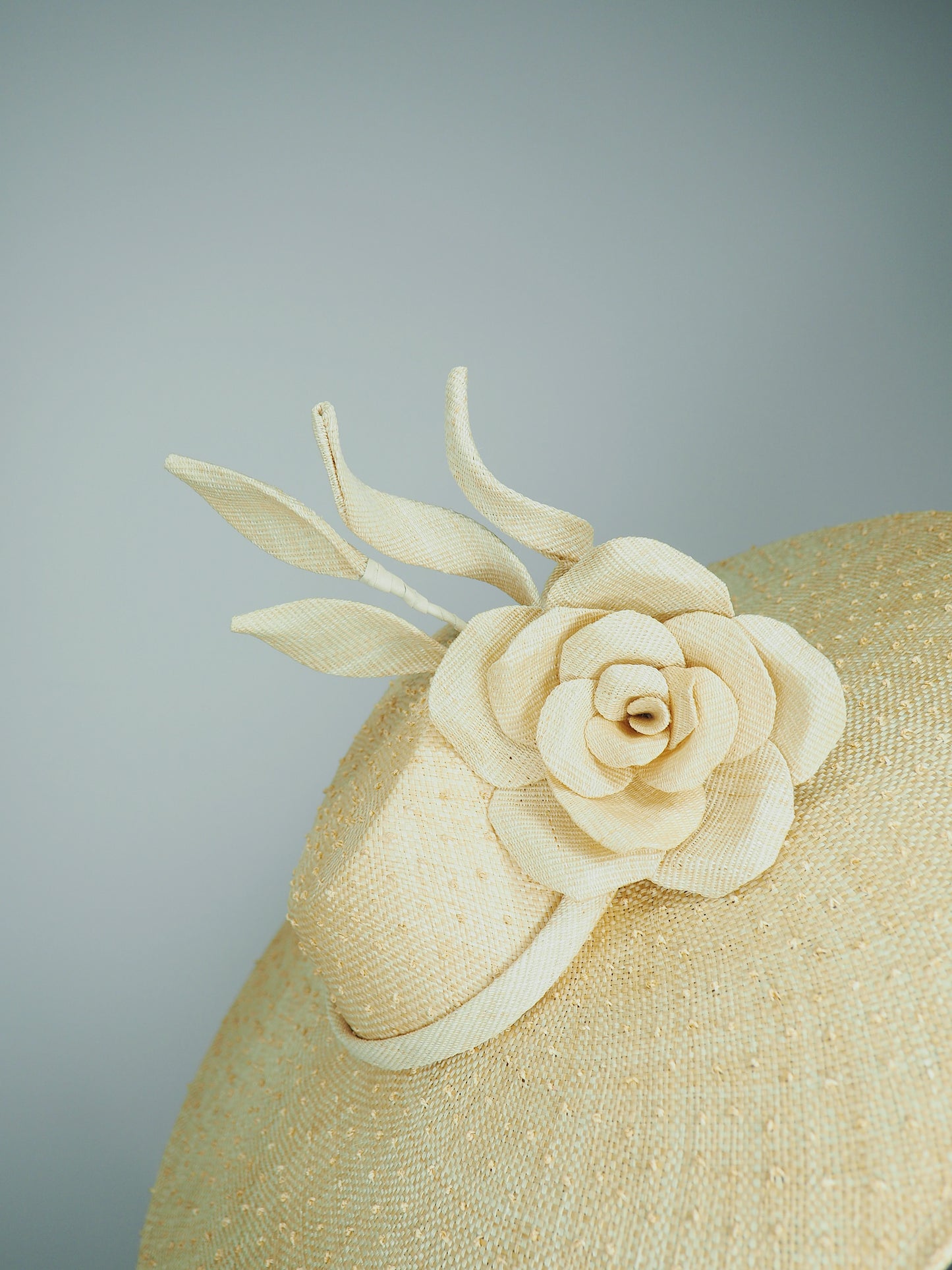 Nature in Bloom-Natural straw asymmetric brim hat with hand-sculpted rose and swirls