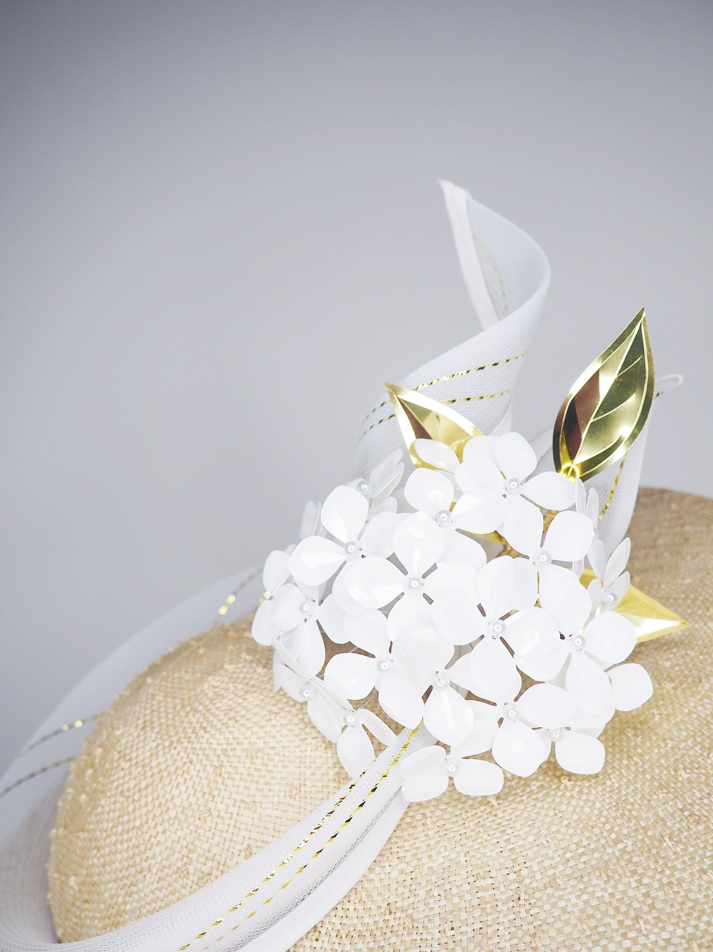 Natural Elegance - Natural knotted straw sloped brim with white hydrangea and gold lurex crinoline straw swirl