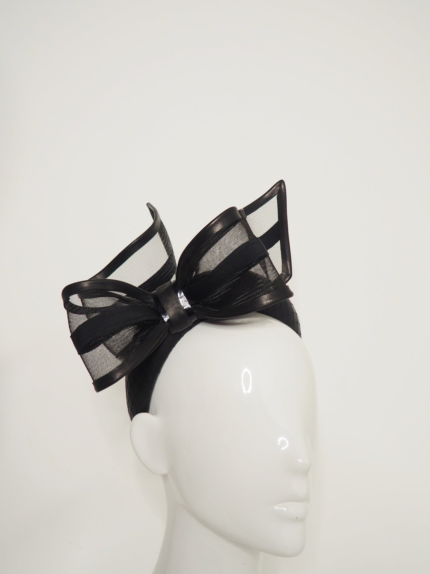 Windswept Bow - Black leather 3d headband with windswept crinoline wired bow.