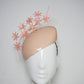 Peachy Pink - Iridescent pastel pink blossoms and quill on a peach blossom sequin facehugger base.