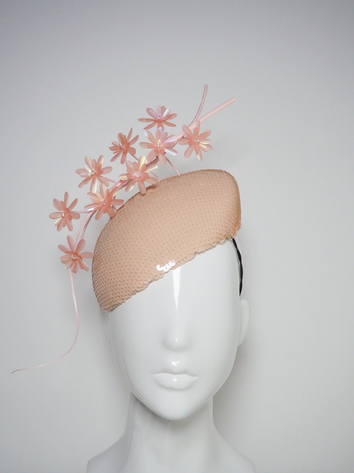 Peachy Pink - Iridescent pastel pink blossoms and quill on a peach blossom sequin facehugger base.