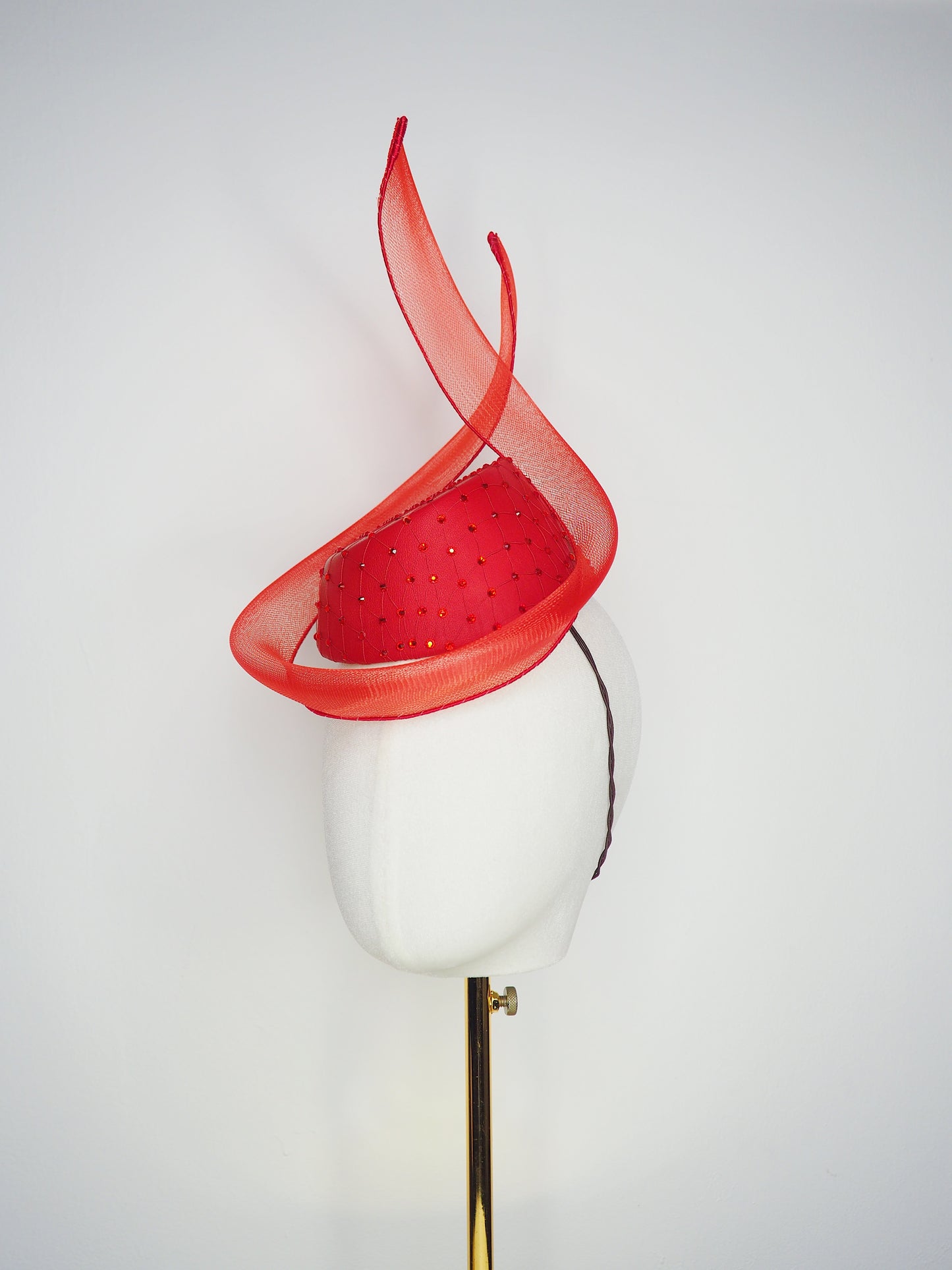 Ember - Red leather pillbox featuring a crystal-encrusted base and sculptural crinoline swirl.