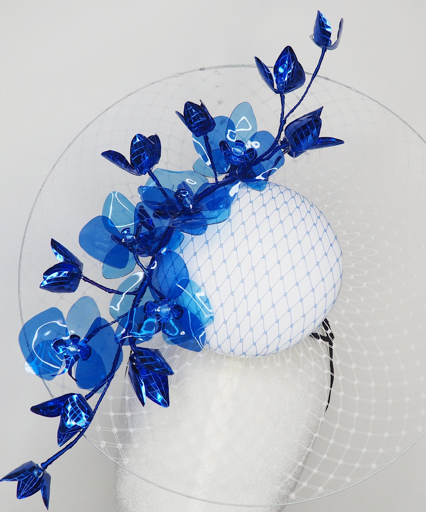 Dancing Orchids - Blue crystoform orchids on a white leather veiles percher base with veil detail