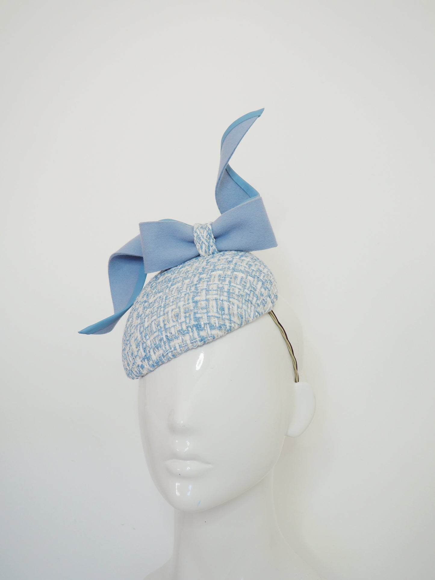 Blue swirl and whirl - Powder blue leather edged wired felt bow on a tweed petite facehugger