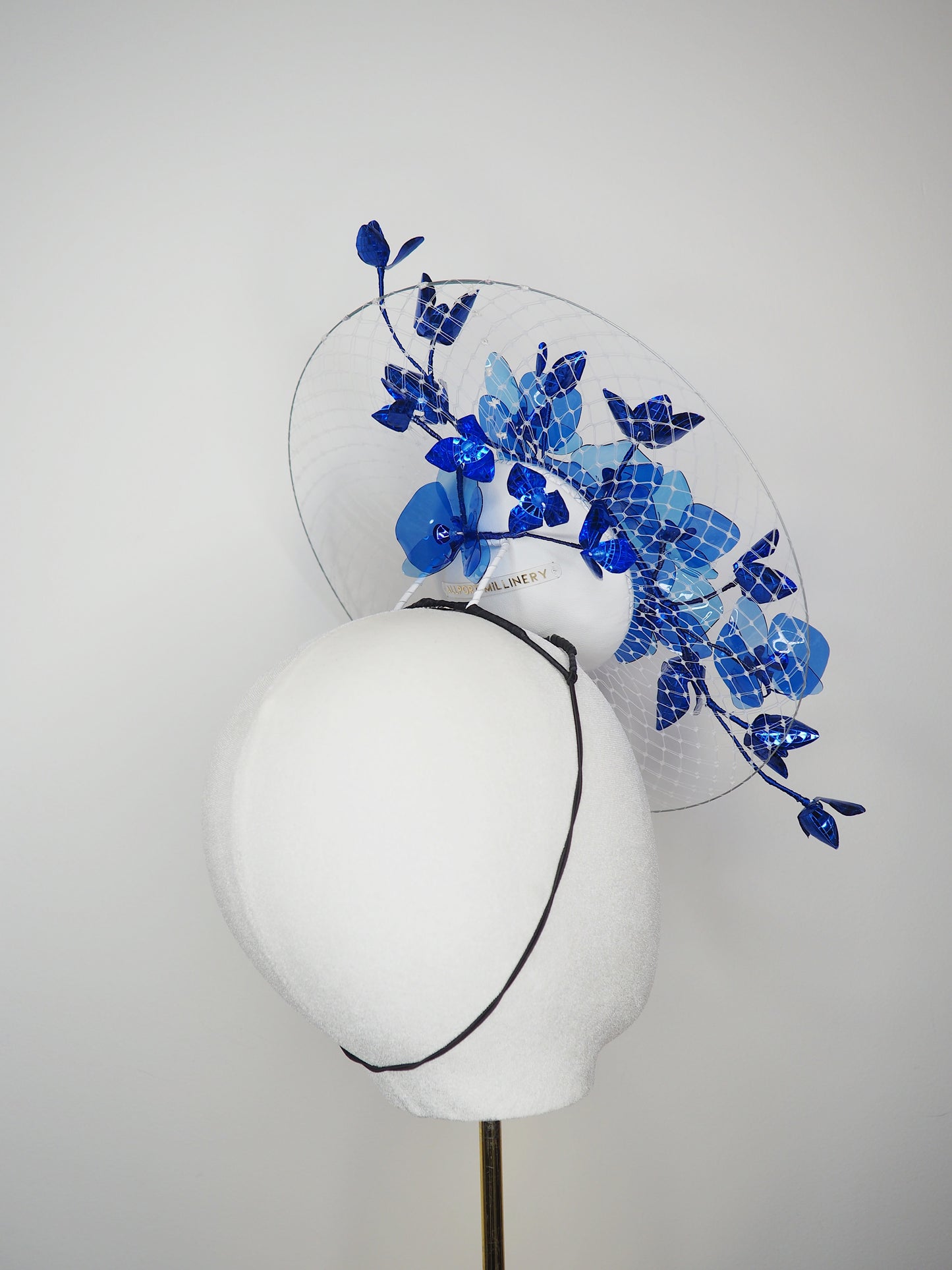 Dancing Orchids - Blue crystoform orchids on a white leather veiles percher base with veil detail