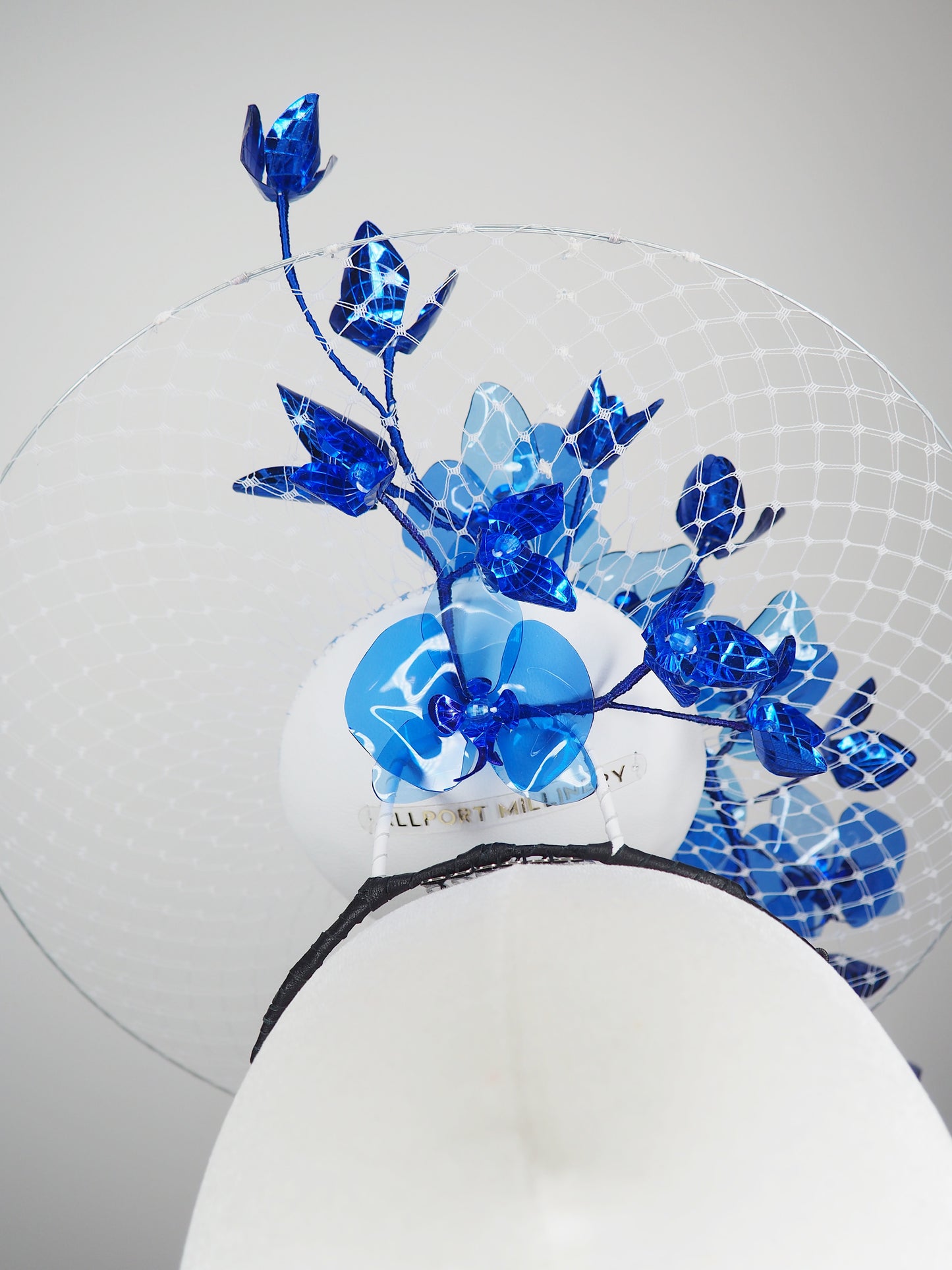 Dancing Orchids - Blue crystoform orchids on a white leather veiles percher base with veil detail