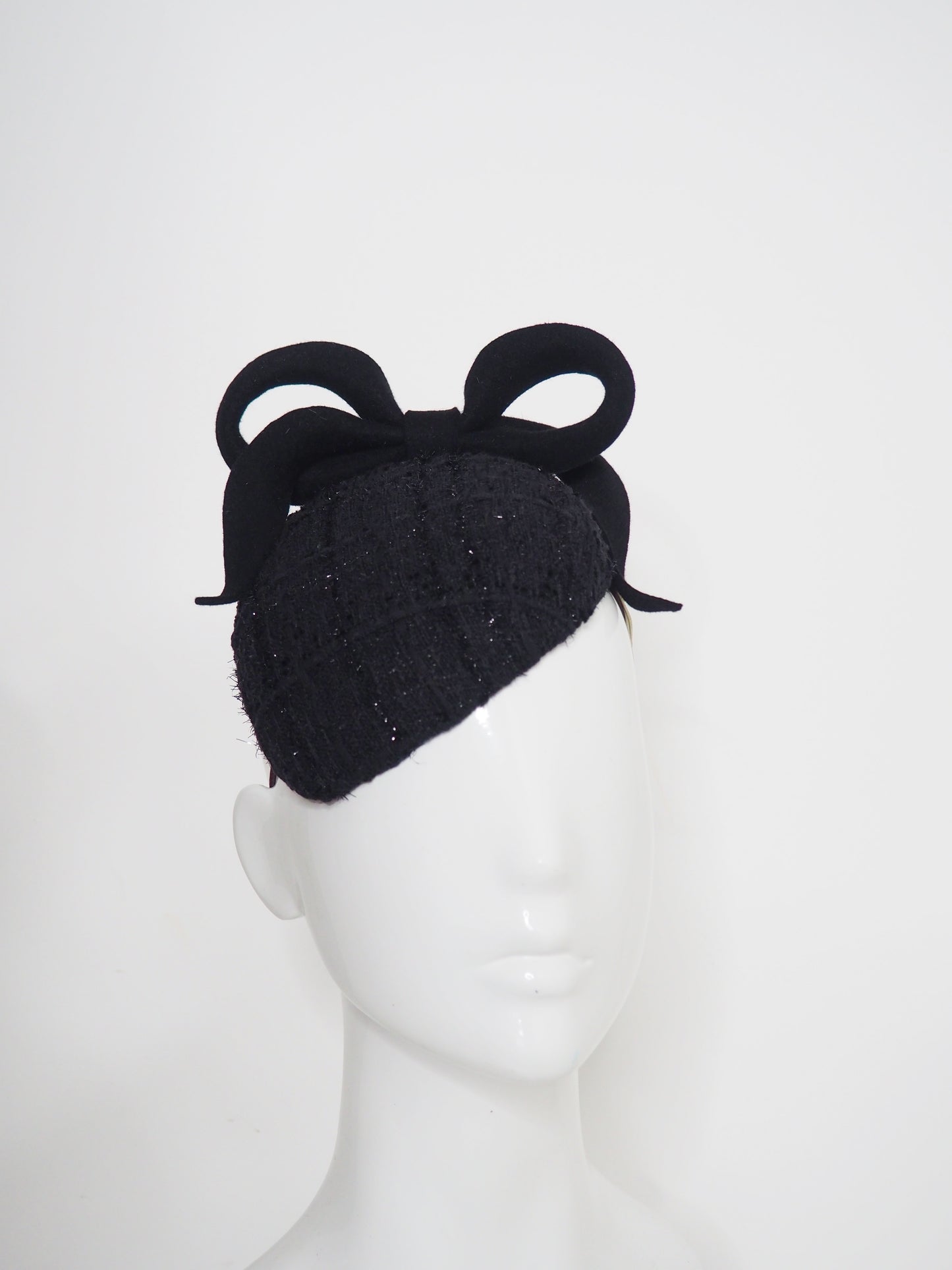 Baby Bow - Black fur felt sculpted bow on a tweed petite facehugger base.