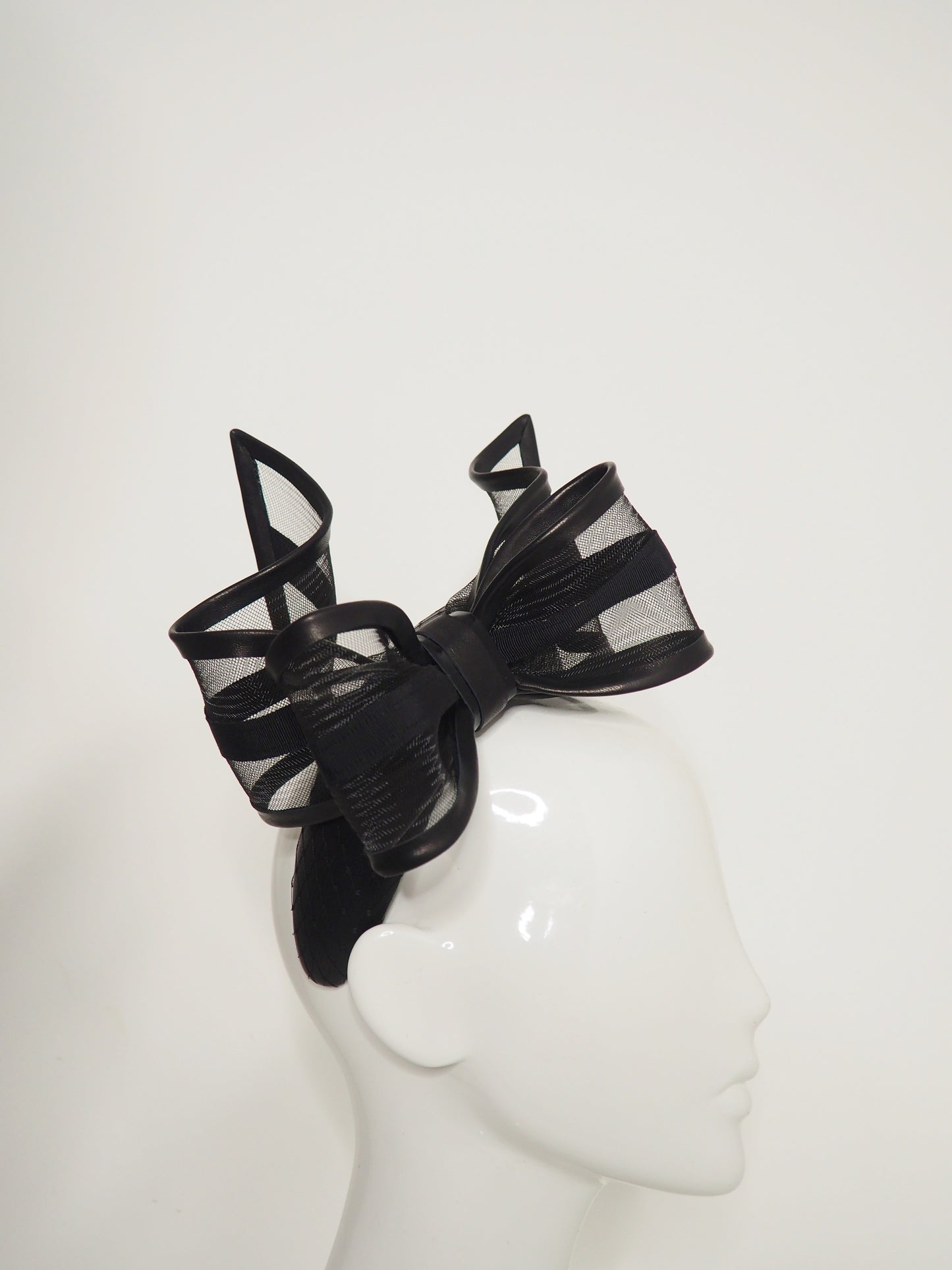 Windswept Bow - Black leather 3d headband with windswept crinoline wired bow.