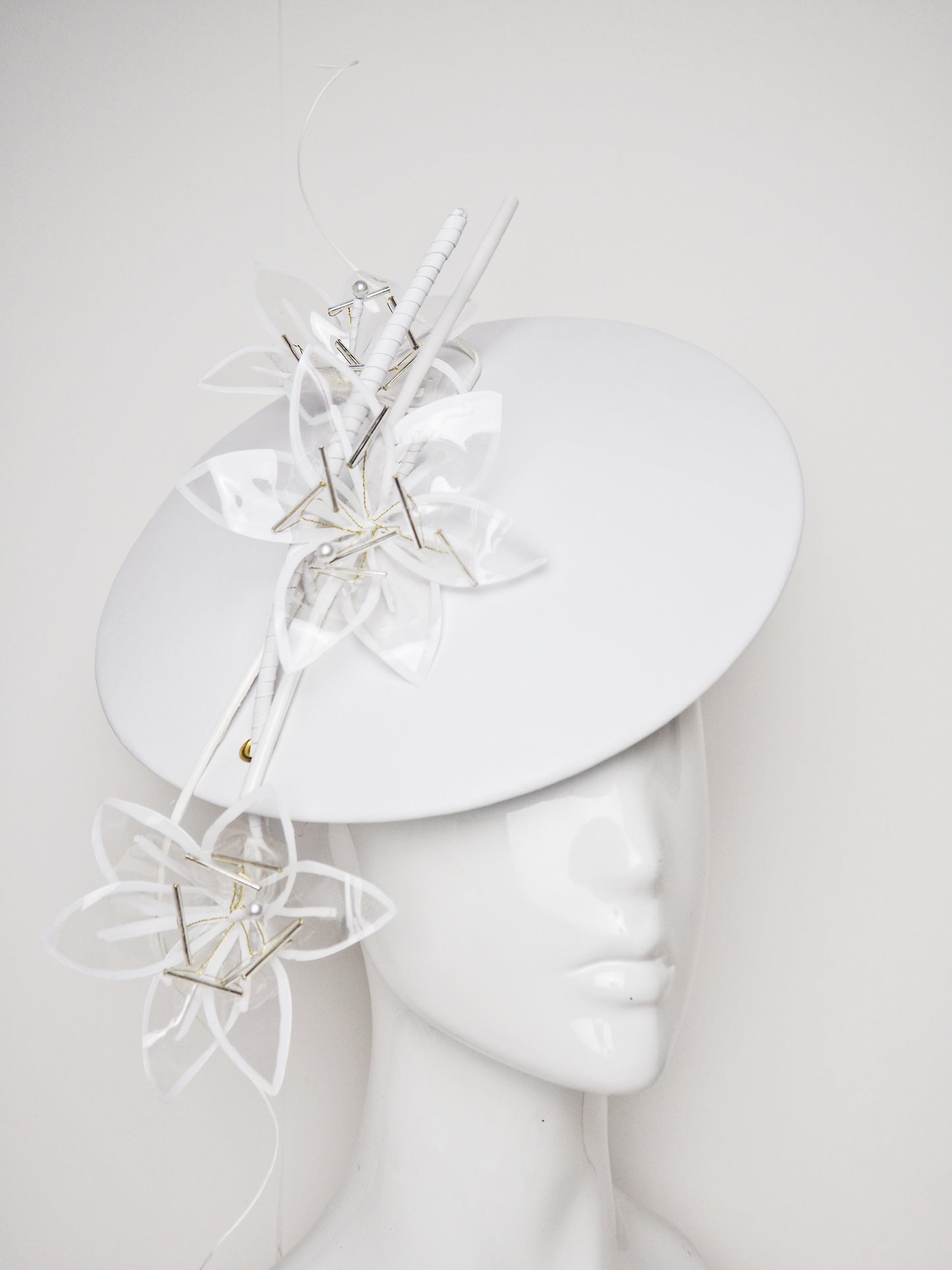 Lys En Blanc - White Crystoform Lillies on a floating leather disk with quill detail.