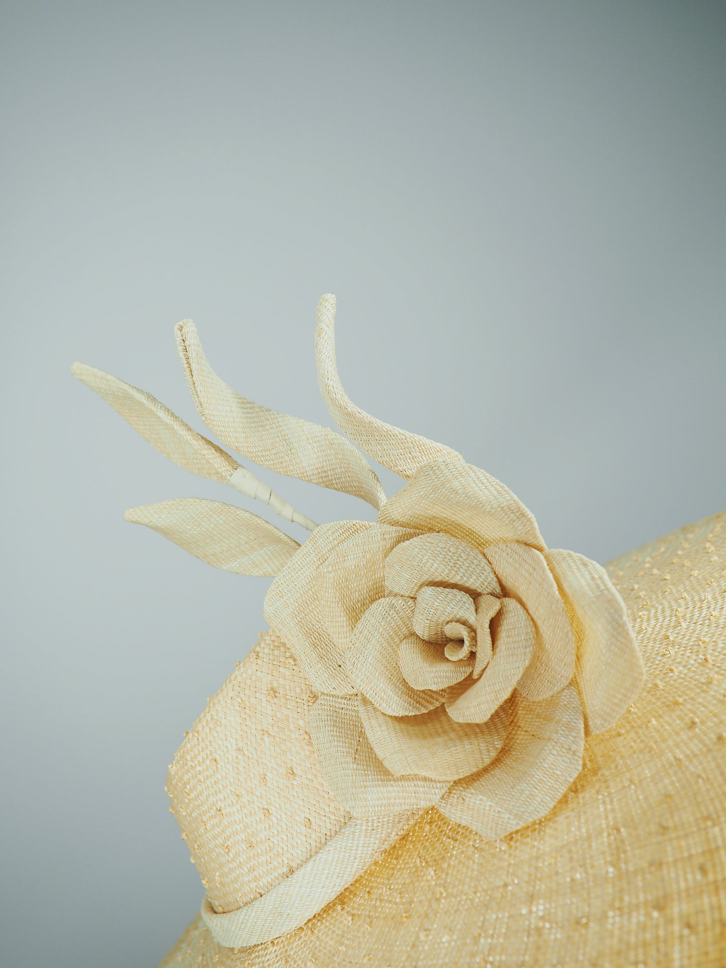 Nature in Bloom-Natural straw asymmetric brim hat with hand-sculpted rose and swirls