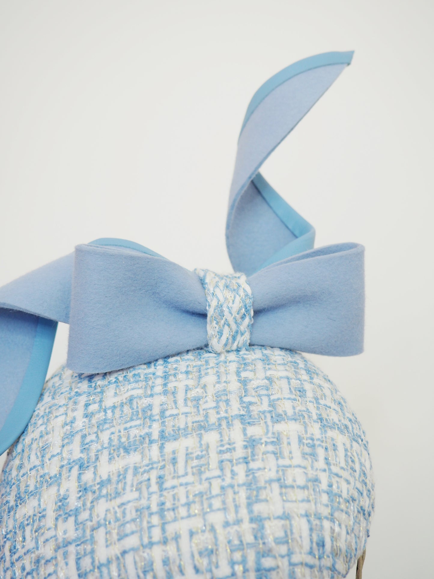 Blue swirl and whirl - Powder blue leather edged wired felt bow on a tweed petite facehugger
