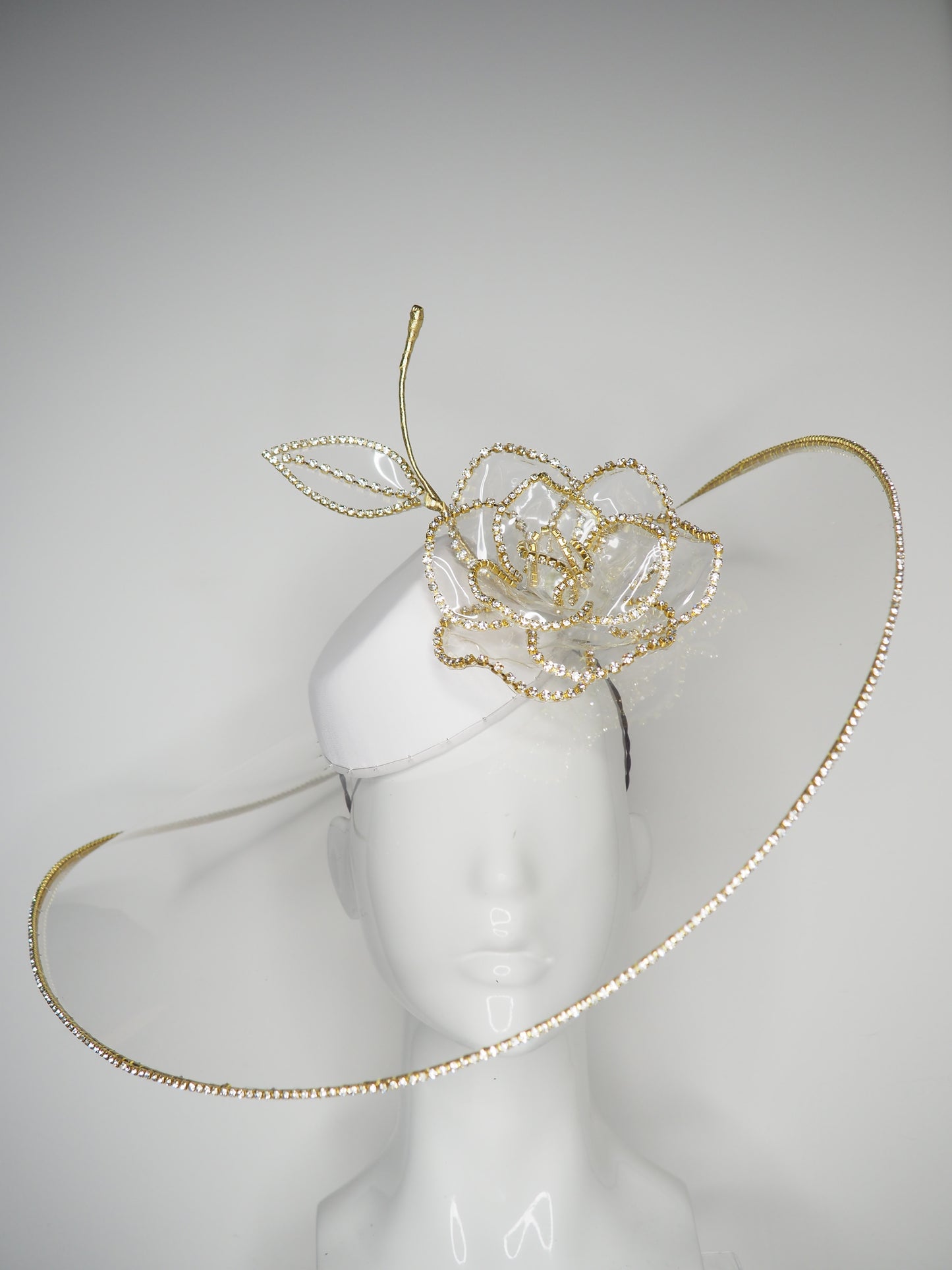 Golden Rose - Transparent peekaboo embellished brim withwhite leather crown and gold crystoform chain rose.