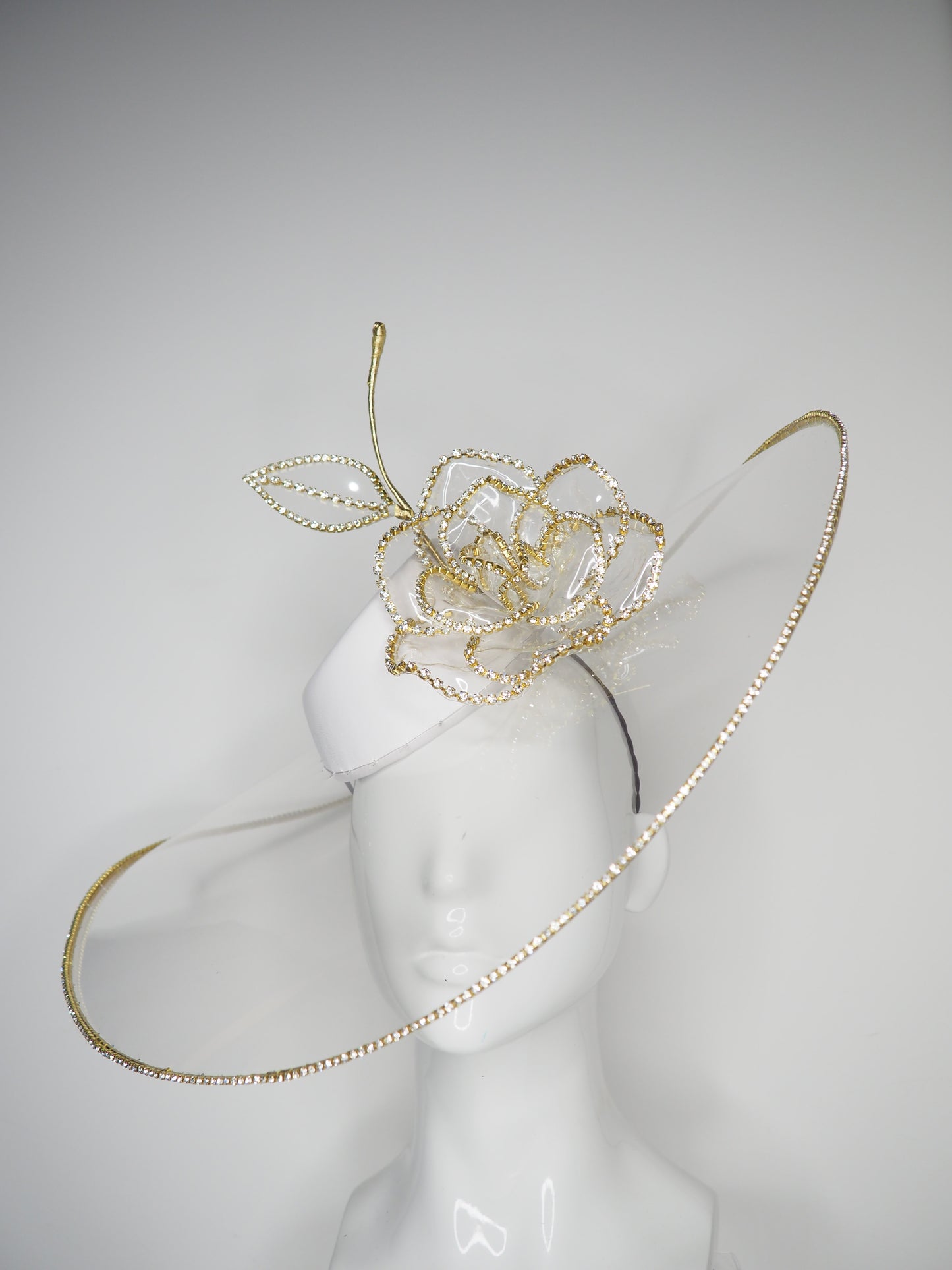 Golden Rose - Transparent peekaboo embellished brim withwhite leather crown and gold crystoform chain rose.