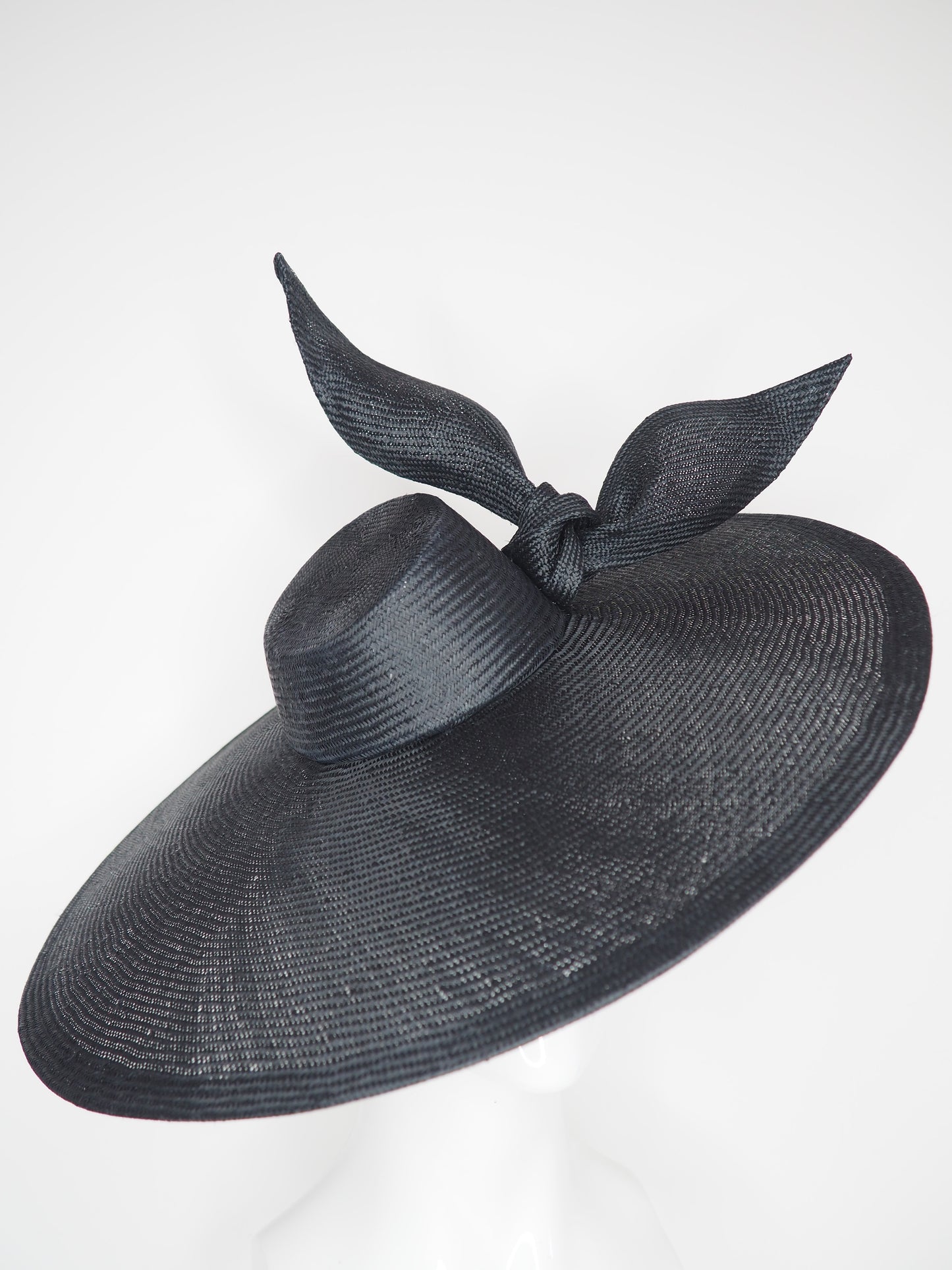 Derby Pose- Slanted brim parisissal straw with asymmetric crown and wires knot detail