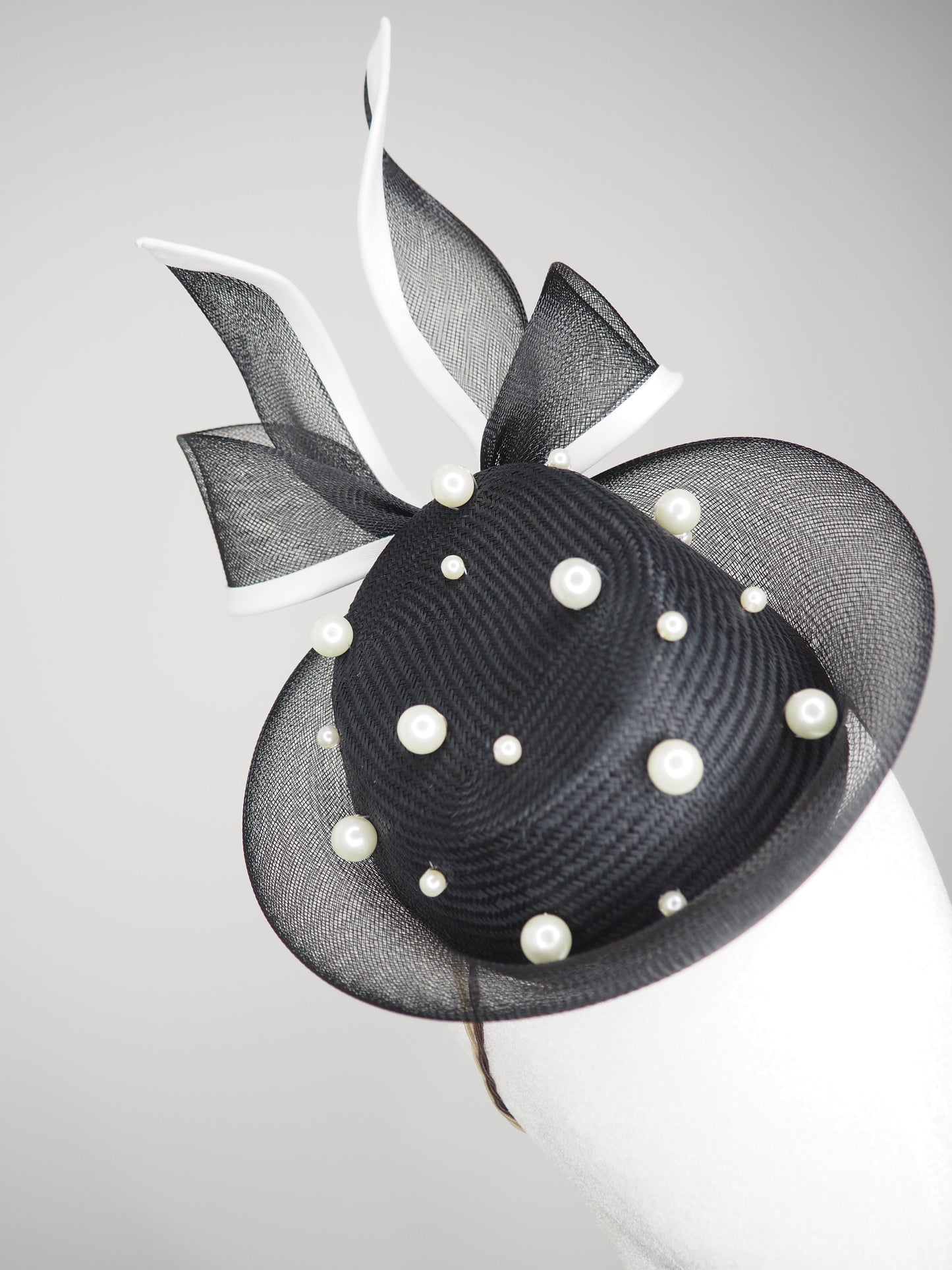 Back Tie pearl - Black asymmetric straw pillbox with wired crinoline bow in black and white and a scattering of pearls
