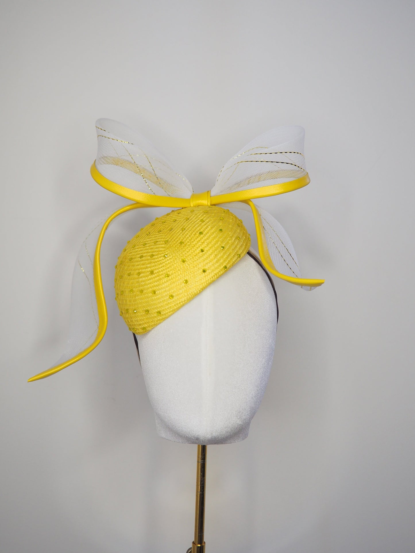 Sunshine - Yellow Petite Facehugger – yellow straw base covered in crystals, with white and gold crinoline bow edged in yellow leather