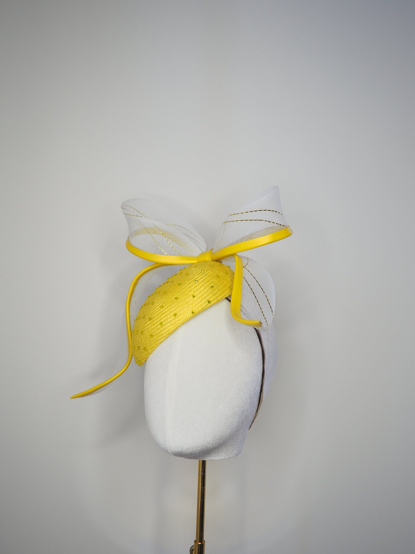 Sunshine - Yellow Petite Facehugger – yellow straw base covered in crystals, with white and gold crinoline bow edged in yellow leather