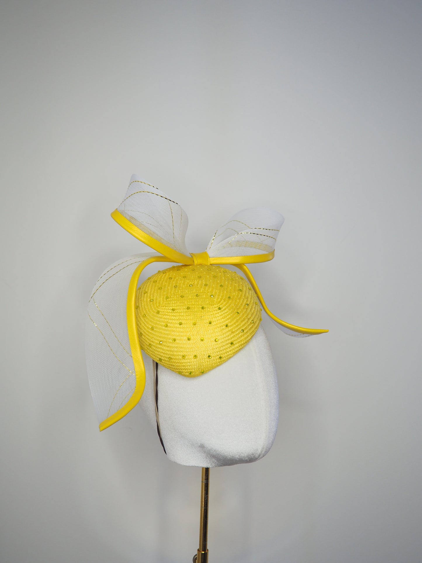 Sunshine - Yellow Petite Facehugger – yellow straw base covered in crystals, with white and gold crinoline bow edged in yellow leather