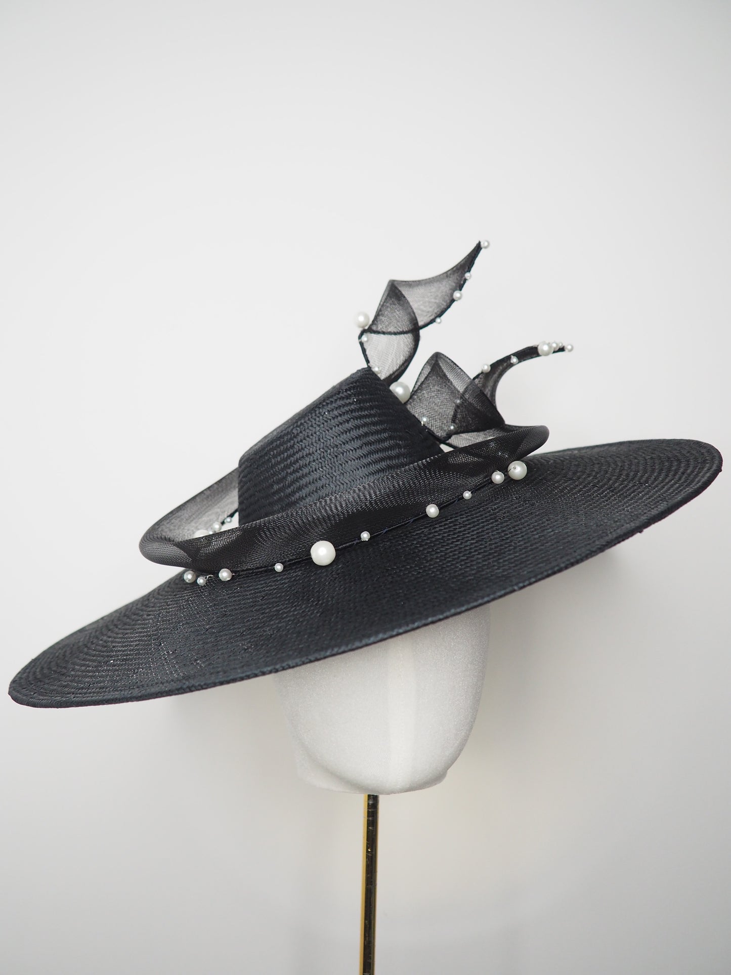 Pearl Noir - Black parasisal asymmetric crown slanted brim hat with sculptural crinoline swirl and pearl accents