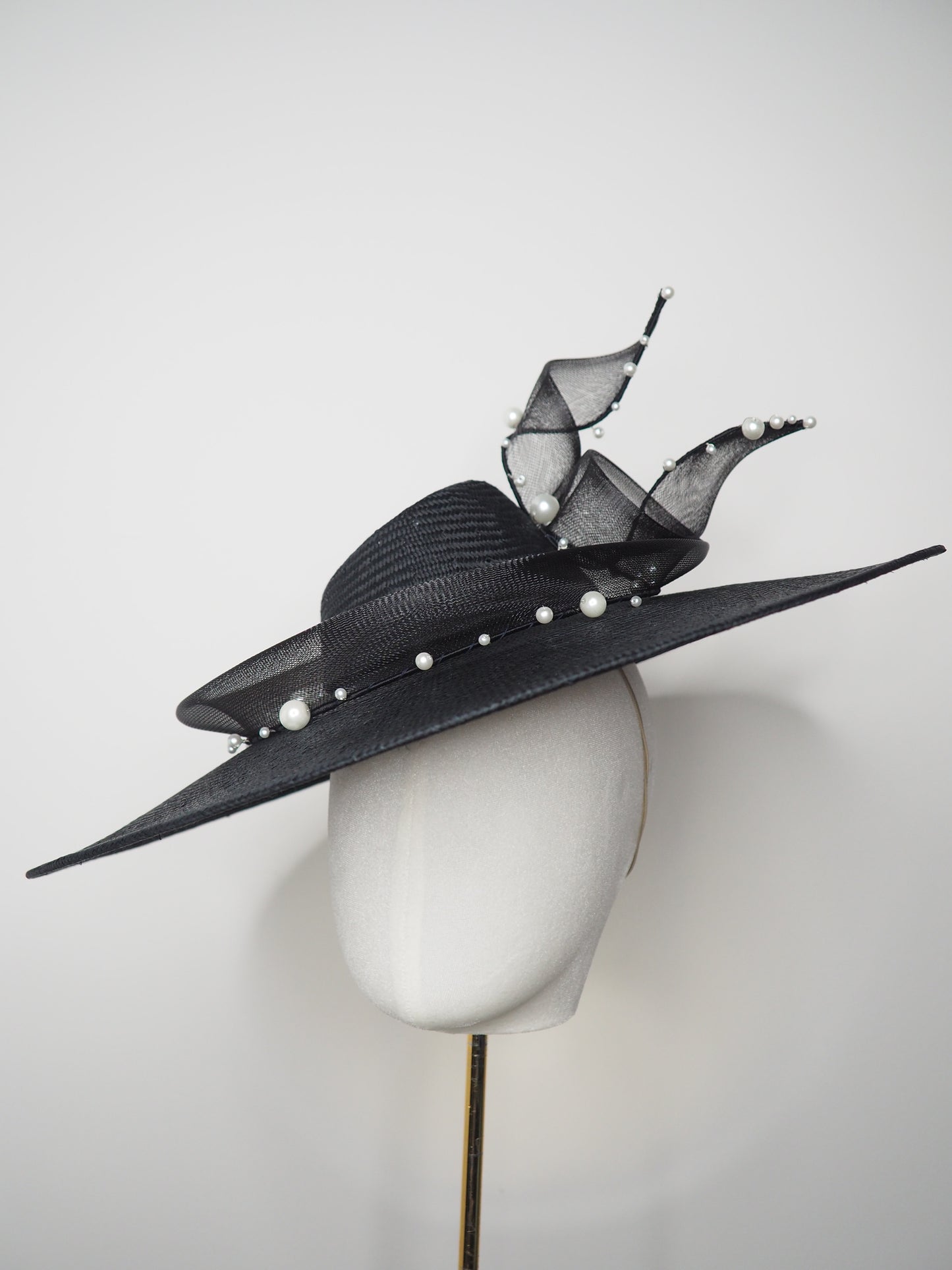 Pearl Noir - Black parasisal asymmetric crown slanted brim hat with sculptural crinoline swirl and pearl accents
