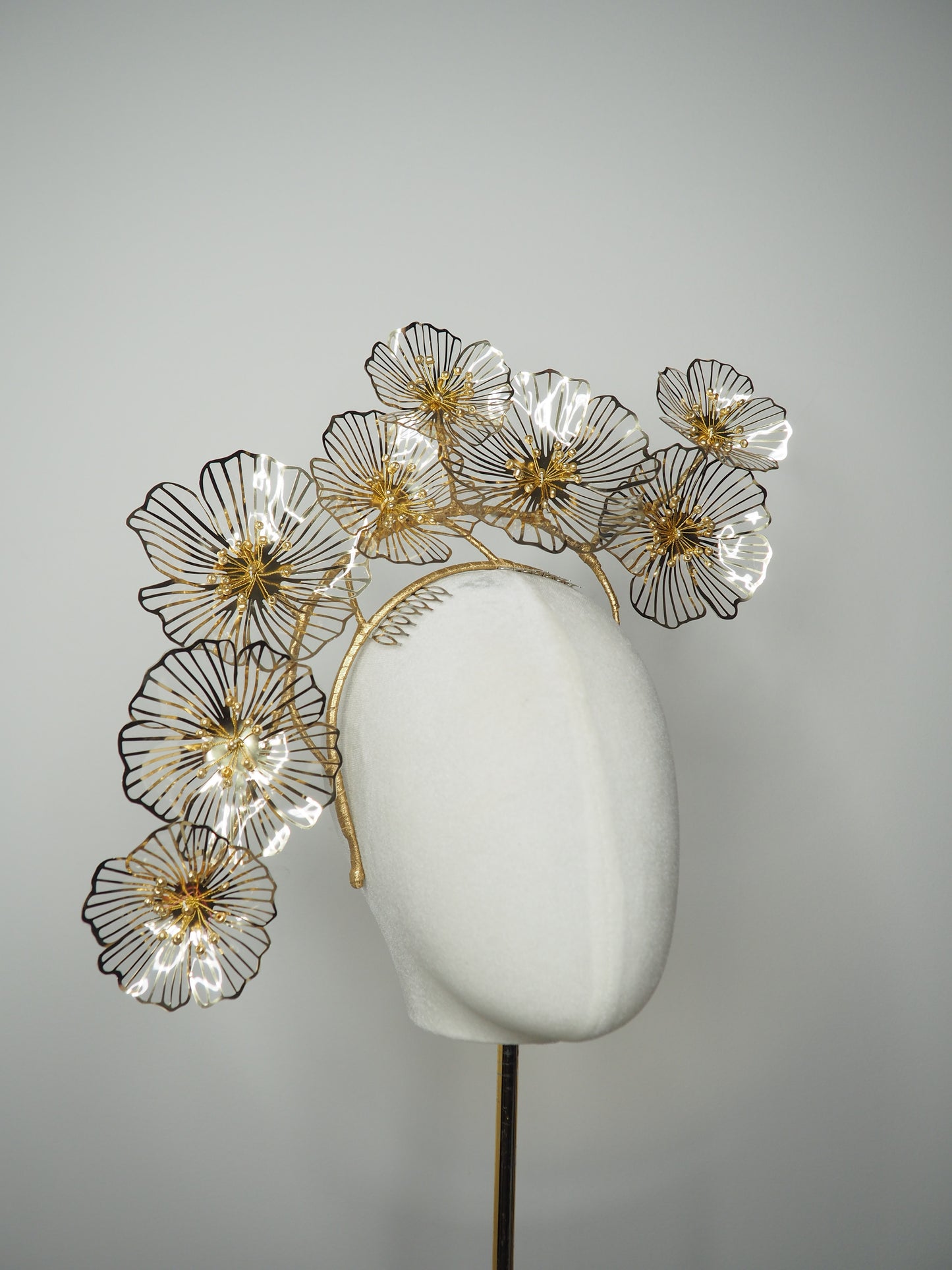 Golden Aura - Gold Crystoform flower headpiece with intricately detailed gold-edged petals on a floating wired frame