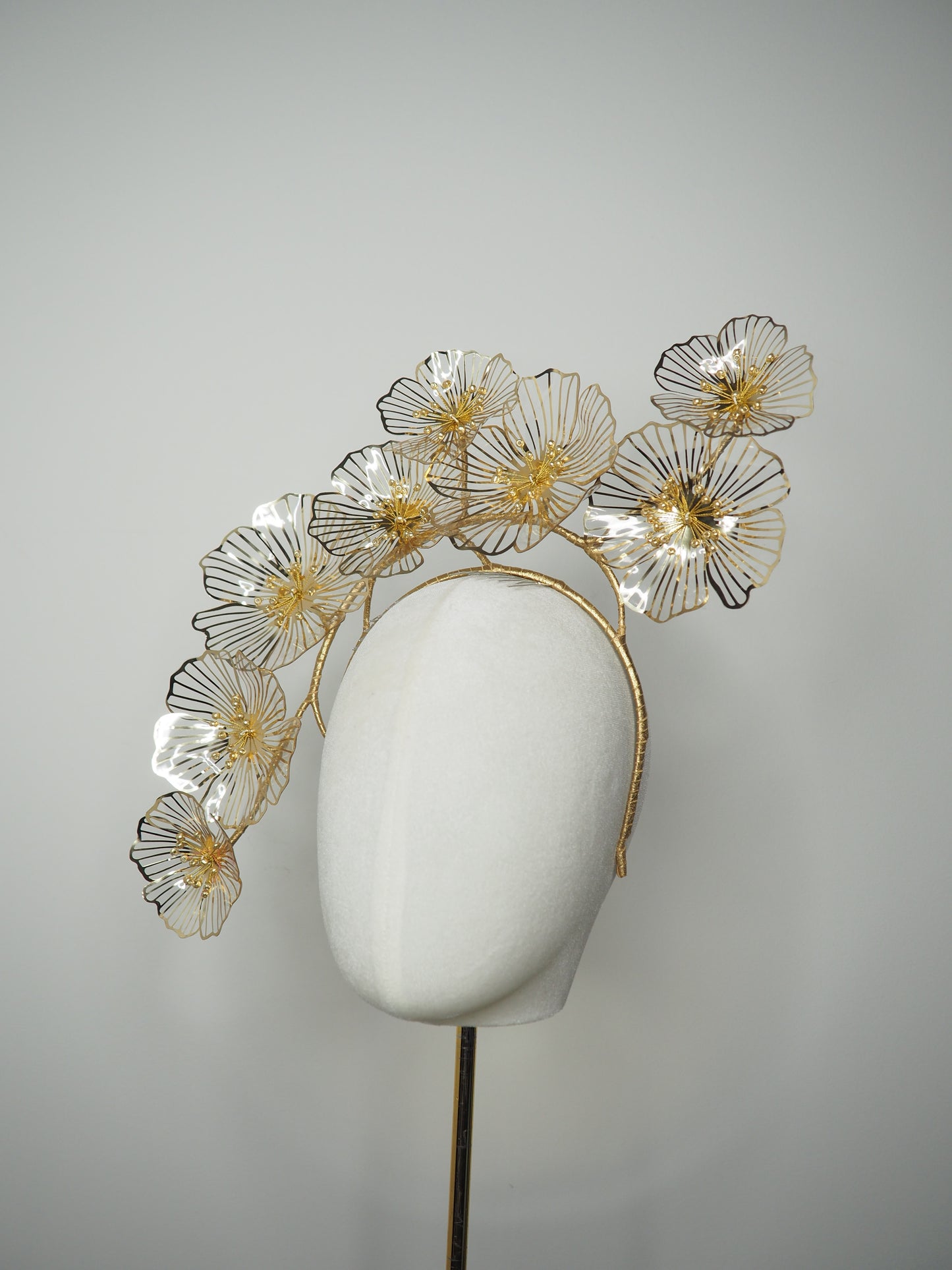 Golden Aura - Gold Crystoform flower headpiece with intricately detailed gold-edged petals on a floating wired frame