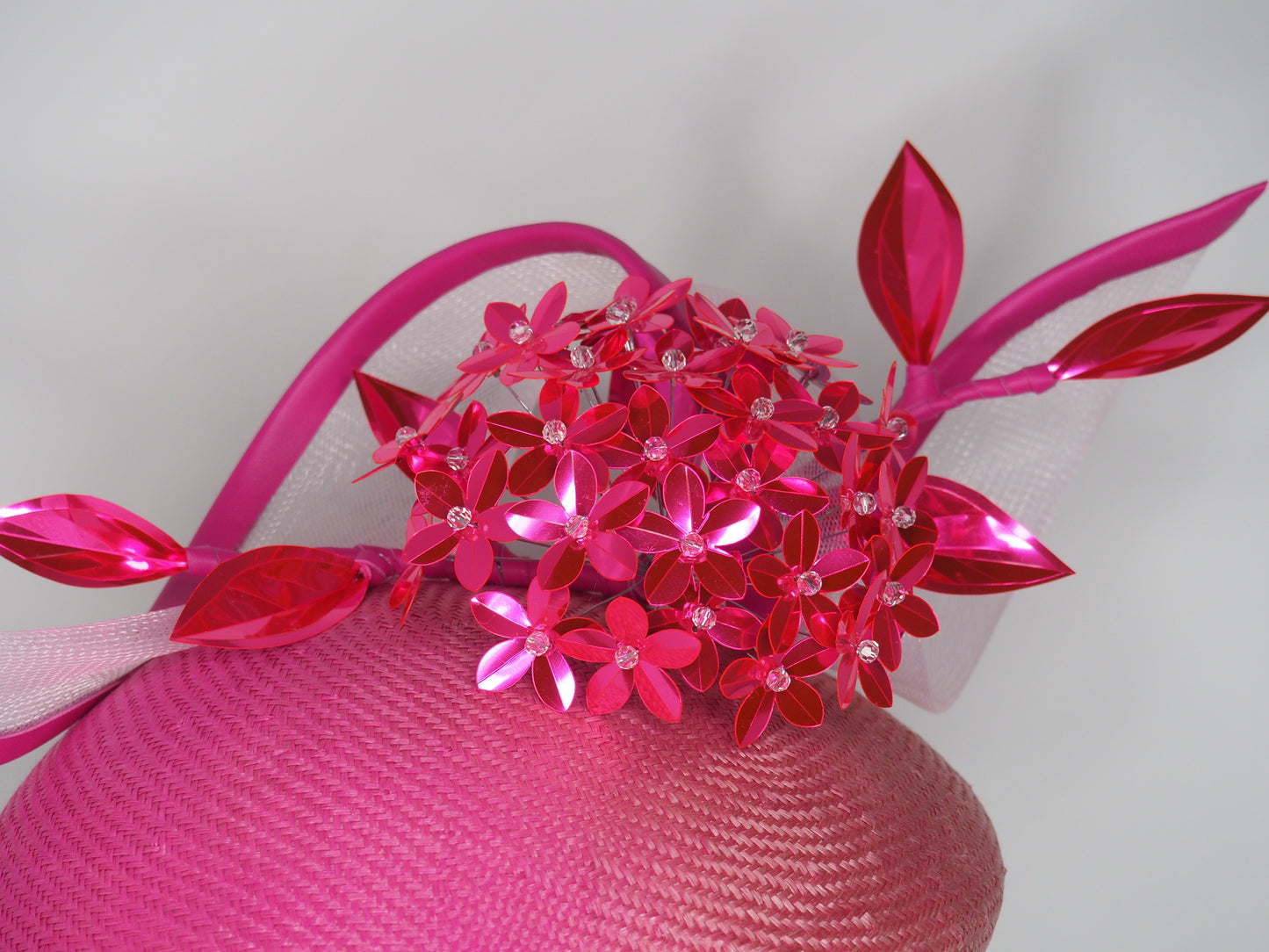 Disco barbie baby - hot pink Alium Flower ball on an ombre straw face hugger with a crinoline swirl headpiece.