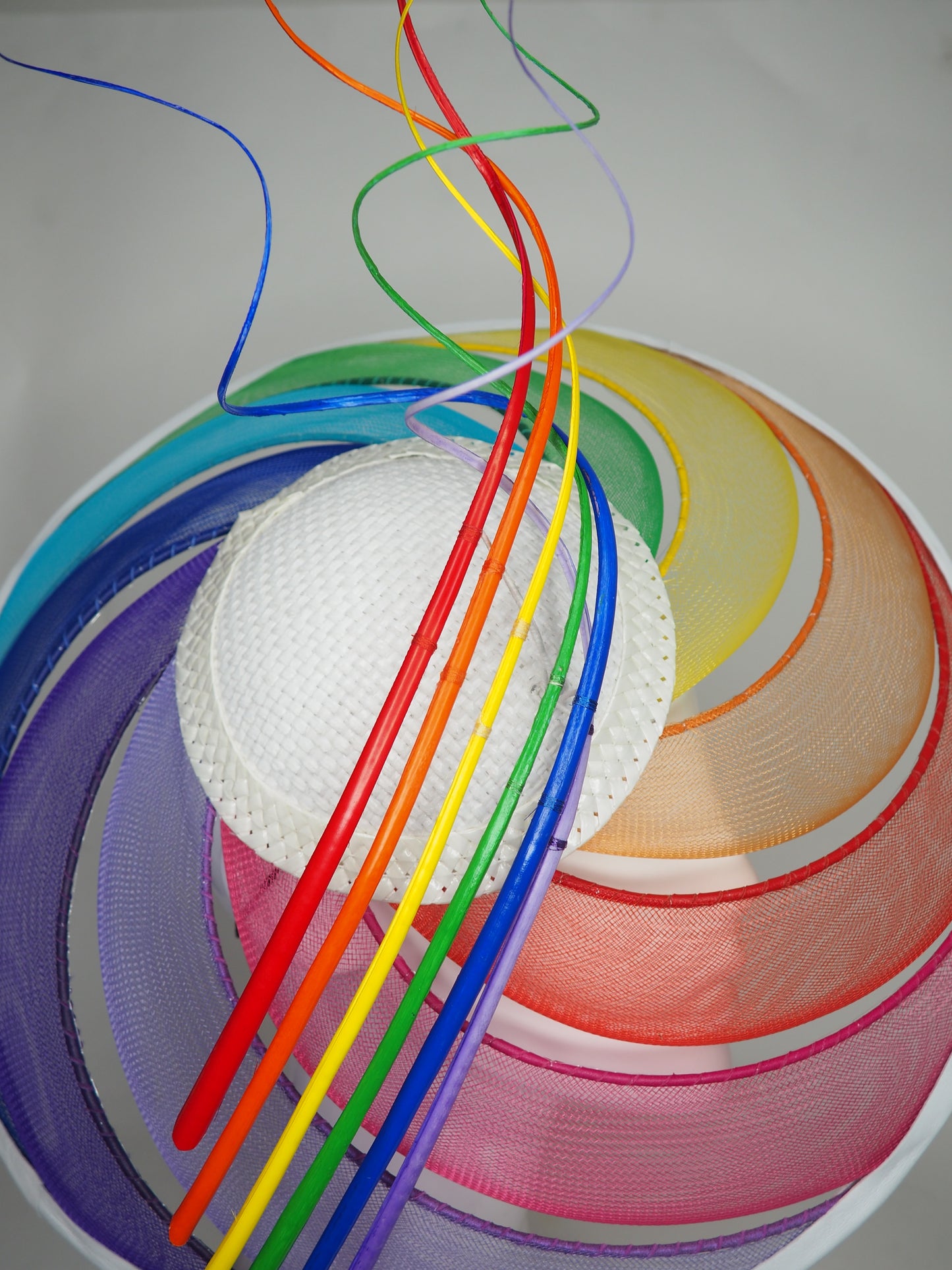 Over The Rainbow - Rainbow crinoline wired brim with textured white crown and rainbow quills.
