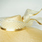 Gilded horizon  - Natural Straw broad brimmed slanted crown parissisal with white and gold lurex leather edged swirl crinoline detail.