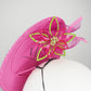A Little Bit Wicked - Candy pink  crystal encrusted leather disc with flower and wired swirl trim.