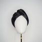 Glass Lake - A sculptural blocked turban crafted from luminous fabric inspired by morning reflections on water.