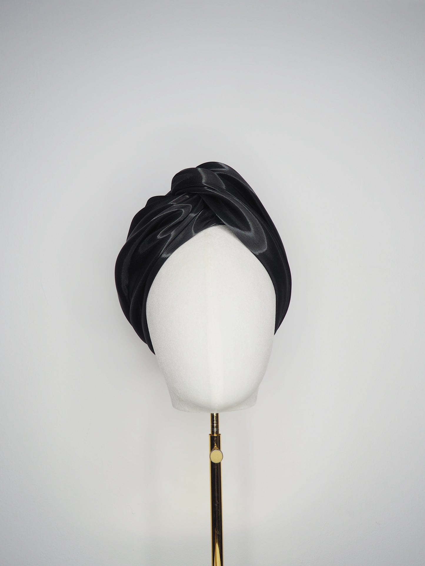 Glass Lake - A sculptural blocked turban crafted from luminous fabric inspired by morning reflections on water.