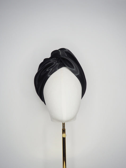 Glass Lake - A sculptural blocked turban crafted from luminous fabric inspired by morning reflections on water.
