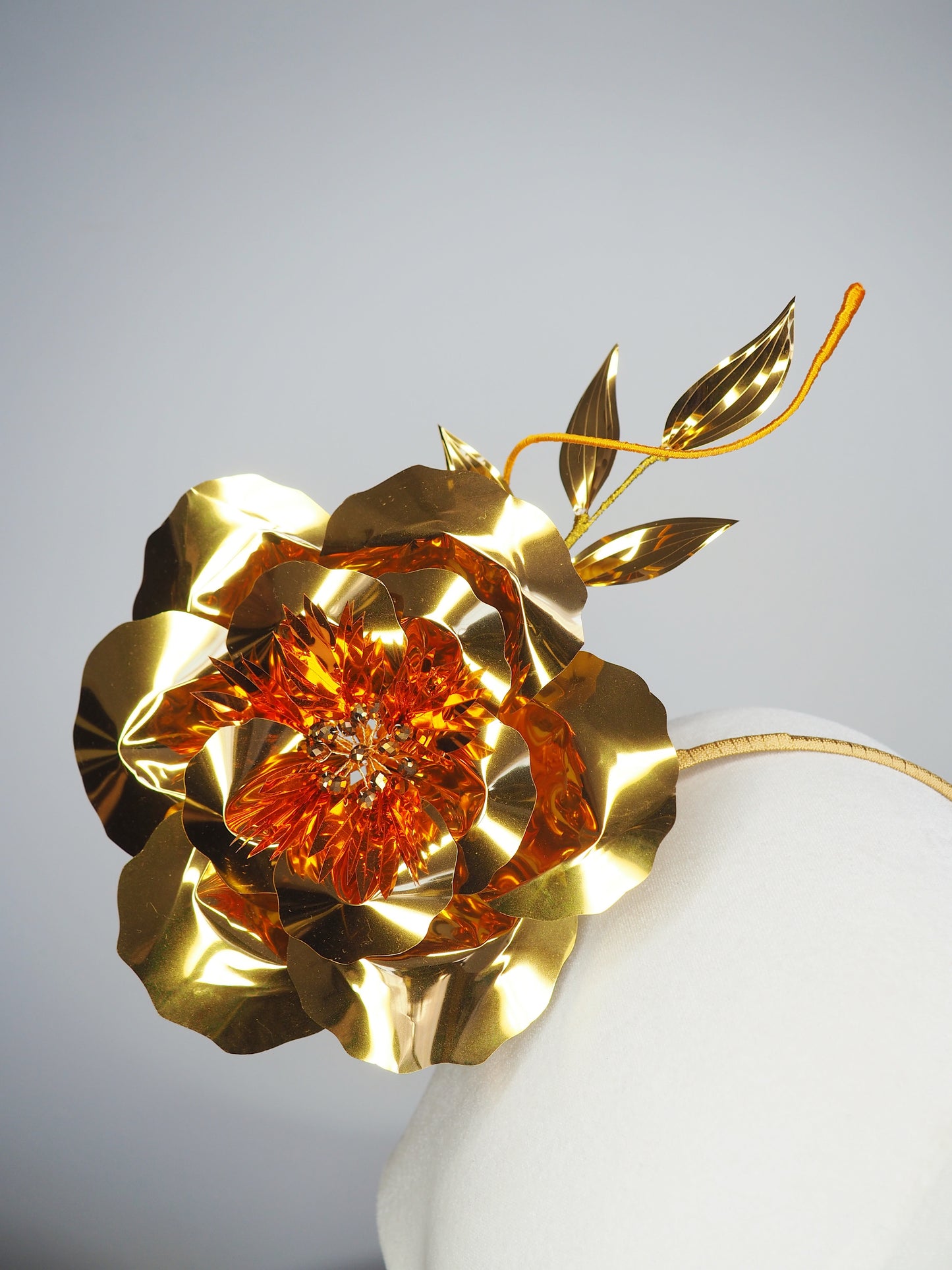Sunlit Bloom - A wraparound floral headpiece featuring oversized golden blooms with vibrant orange centres.