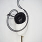 Black Swan - A sleek black lurex pillbox inspired by the graceful silhouette of a swan gliding across water.