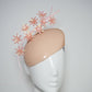 Peachy Pink - Iridescent pastel pink blossoms and quill on a peach blossom sequin facehugger base.