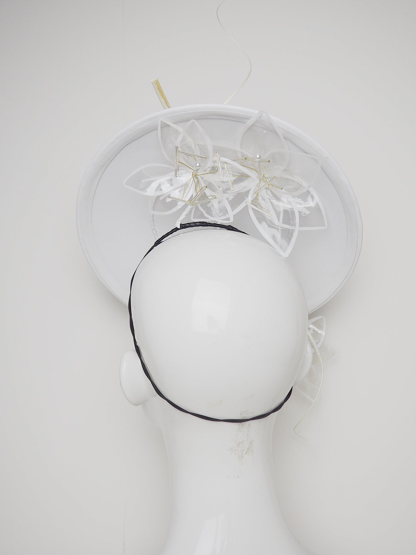 Lys En Blanc - White Crystoform Lillies on a floating leather disk with quill detail.