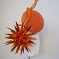 Solar Spark - Round gold and orange percher with orange sequin film starburst and gold quill detail