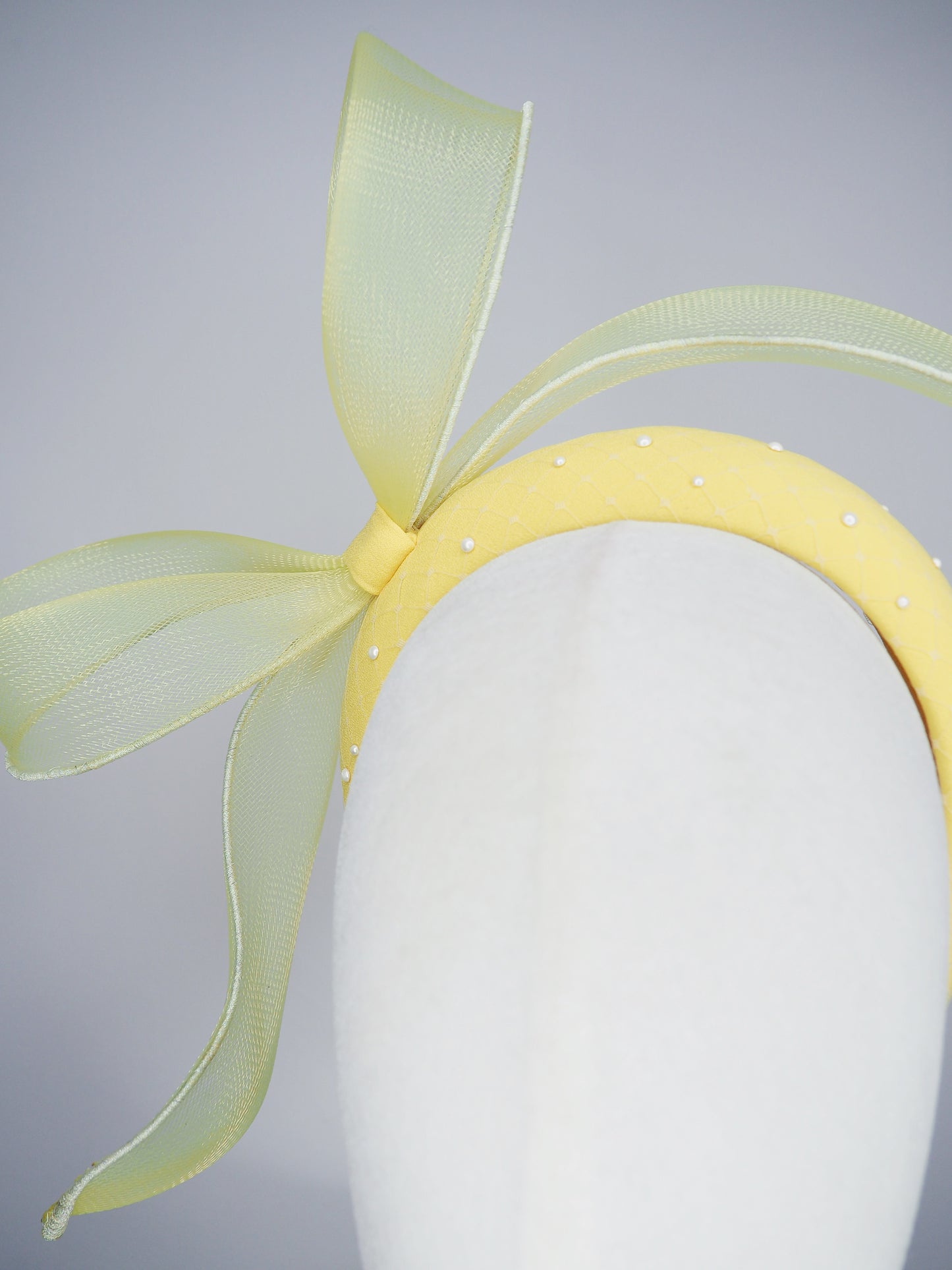 Soleil - A joyful lemon bow headpiece with pearl encrusted veil detail
