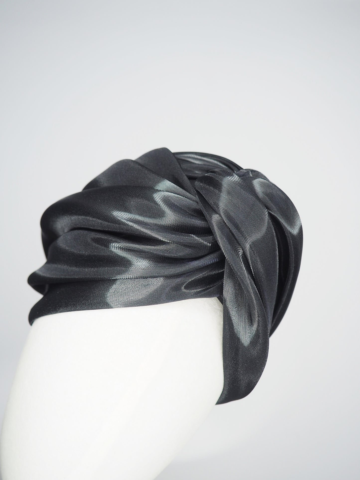 Glass Lake - A sculptural blocked turban crafted from luminous fabric inspired by morning reflections on water.