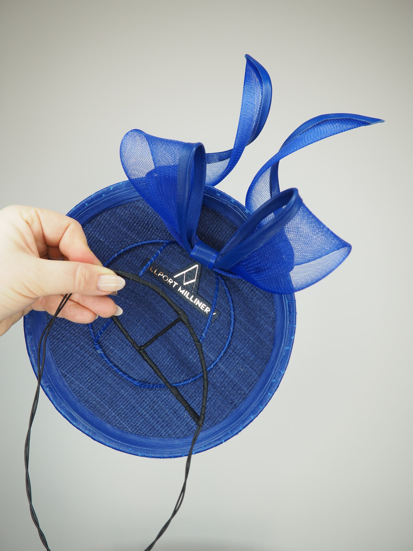 Sapphire Shimmer - Blue floating disc with leather bound crinoline bow and crystal embellsihed veil