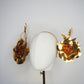 Sunlit Bloom - A wraparound floral headpiece featuring oversized golden blooms with vibrant orange centres.