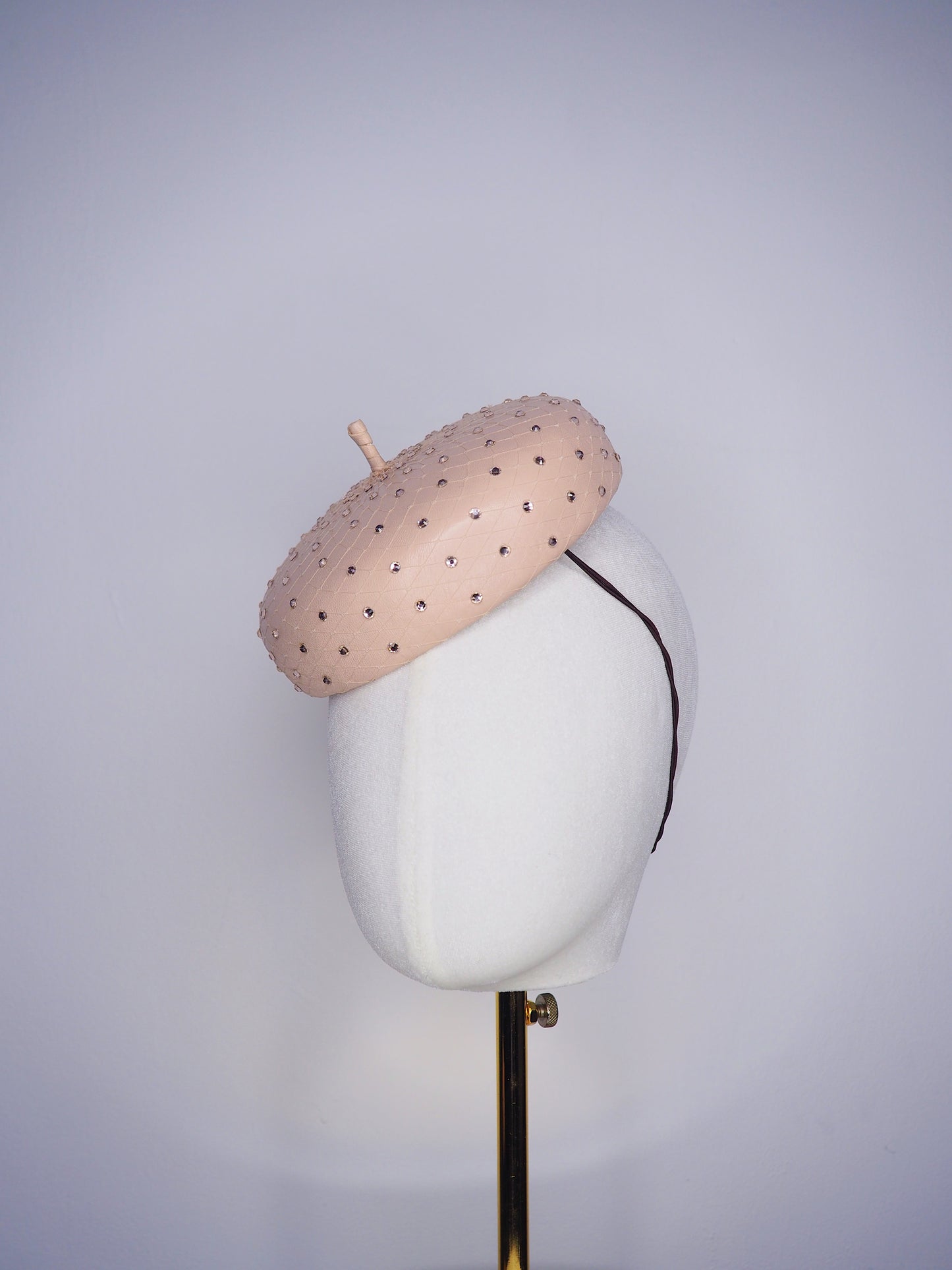 Morning Glow - A timeless nude button fascinator finished with blush crystals and elegant veiling.