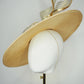 Gilded horizon  - Natural Straw broad brimmed slanted crown parissisal with white and gold lurex leather edged swirl crinoline detail.