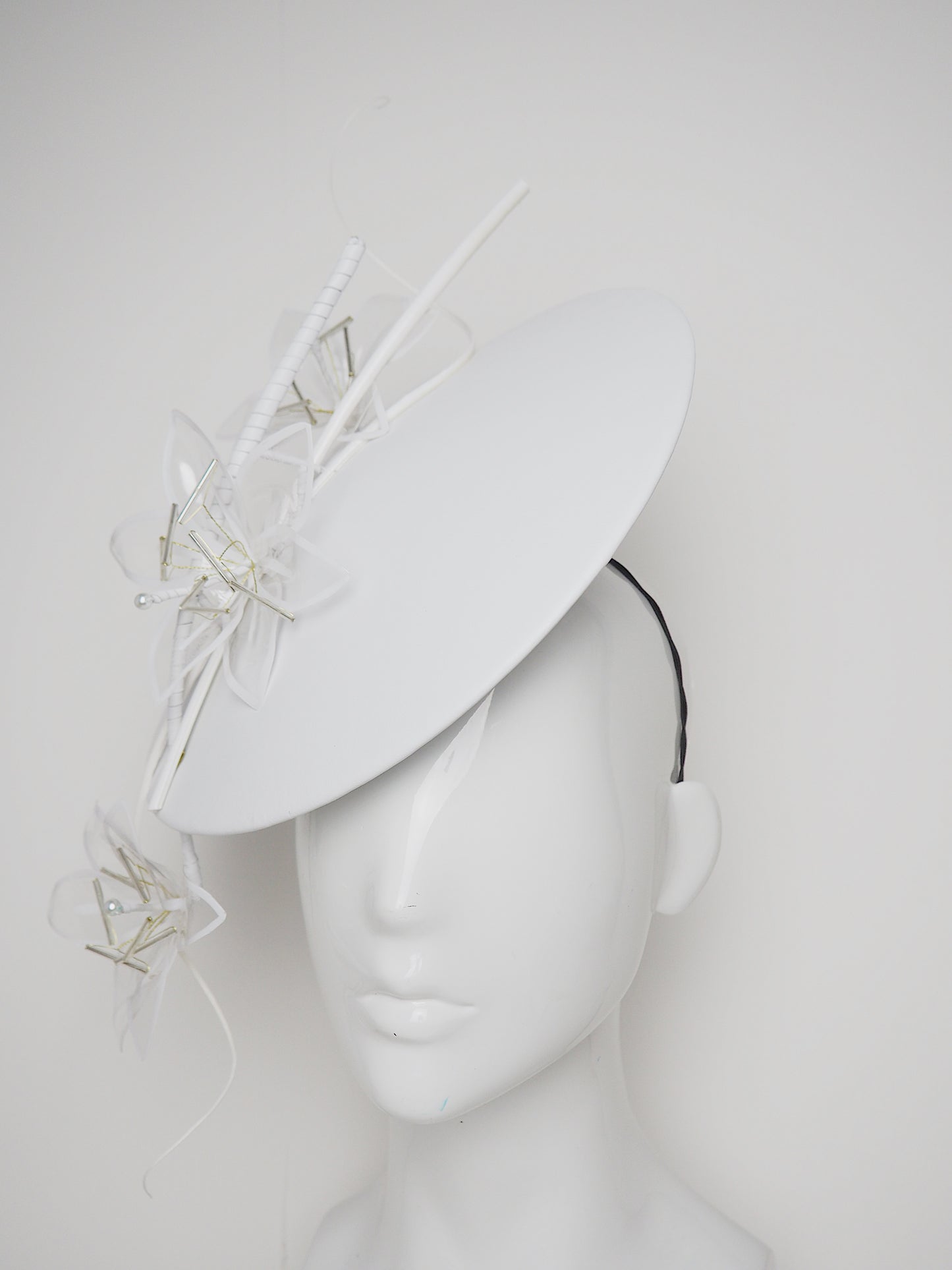 Lys En Blanc - White Crystoform Lillies on a floating leather disk with quill detail.