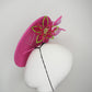 A Little Bit Wicked - Candy pink  crystal encrusted leather disc with flower and wired swirl trim.